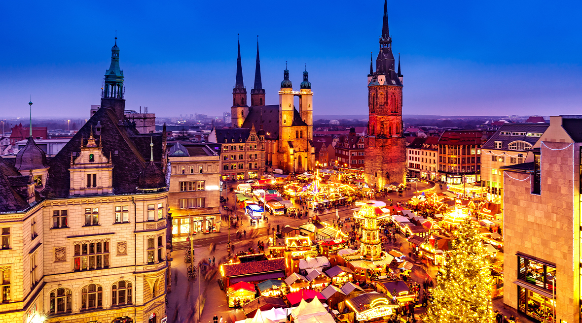 Stunning lit up town with Christmas market surrounded by picturesque architecture